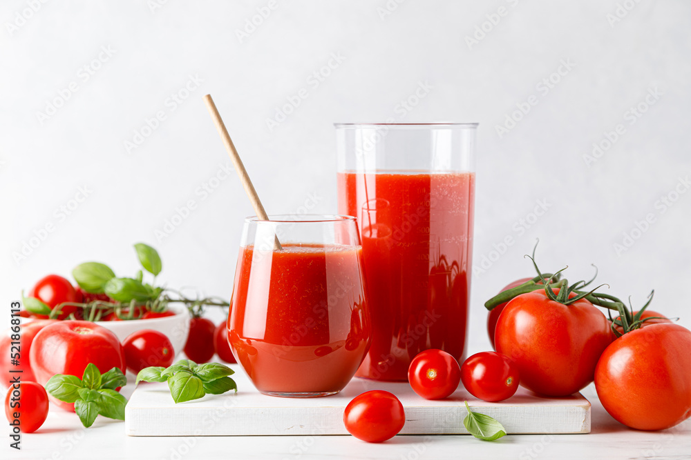 Tomato juice in a glass and fresh tomatoes Tomato juice in a glass and fresh tomatoes