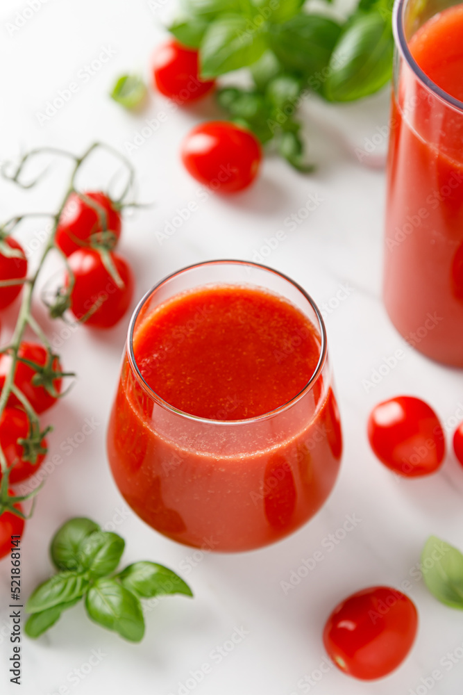 Tomato juice in a glass and fresh tomatoes