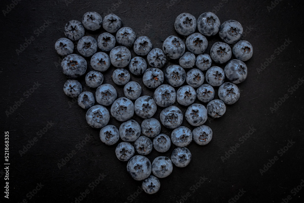 Handful of blueberries on black background. Handful of blueberries Ripe berries. Healthy Lifestyle. Useful products. Lots of vitamins. Handful of blueberries on black background. Handful of blueberries Ripe berries. Healthy Lifestyle. Useful products. Lots of vitamins.