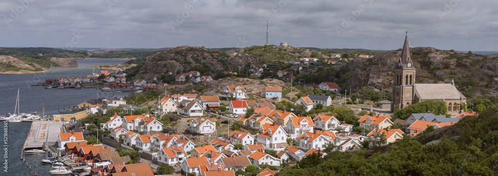 Panoramic view from the Vetteberget cliff to the picturesque harbour of the coastal town of Fjällbacka .