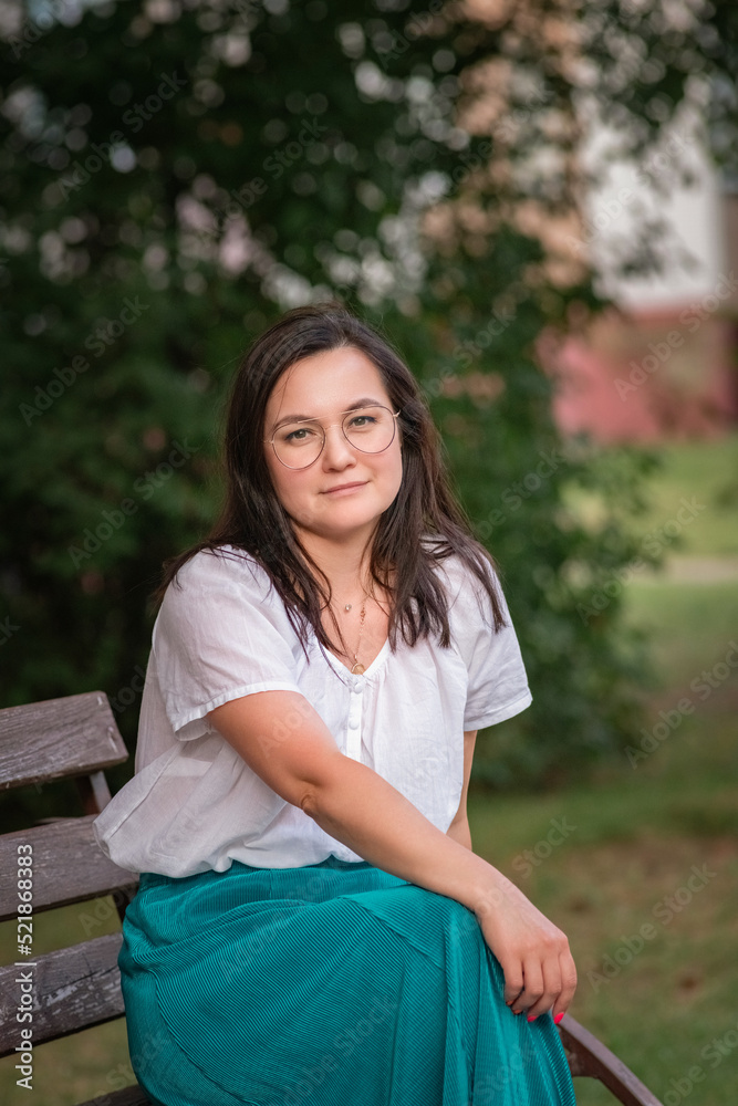 Portrait of a young beautiful dark-haired girl in the park. Close-up, there is artistic noise. Portrait of a young beautiful dark-haired girl in the park. Close-up, there is artistic noise.
