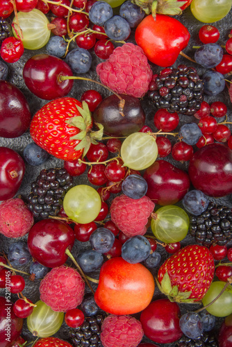 Fototapeta Naklejka Na Ścianę i Meble -  Various summer Fresh berries in a bowl on rustic wooden table. Antioxidants, detox diet, organic fruits. Top view