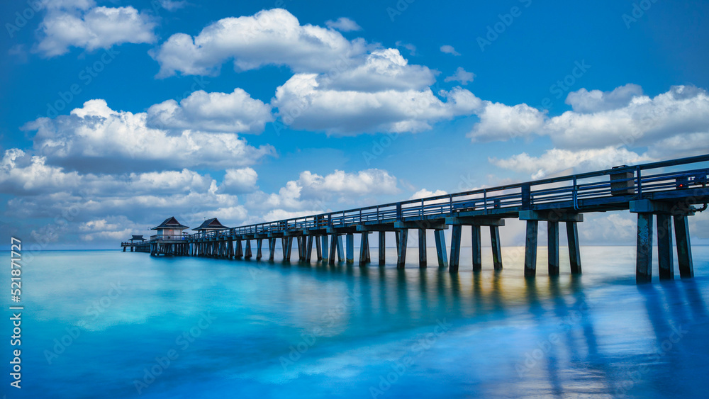 Naples Pier on the beach, sunny day with beautiful clouds in Naples, Florida, USA