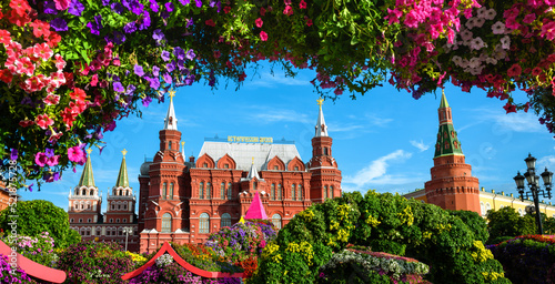Flowers on Manezhnaya Square, Moscow, Russia. Historical Museum (it's written on roof) and Moscow Kremlin in background