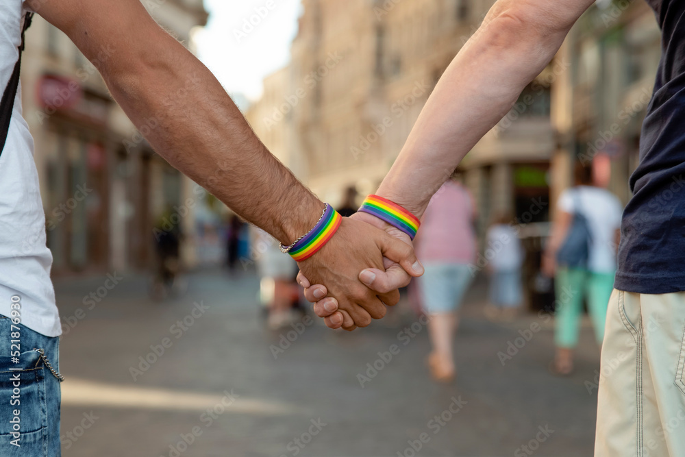 Obraz premium Two men walking around a European city with lgbt symbols, concept