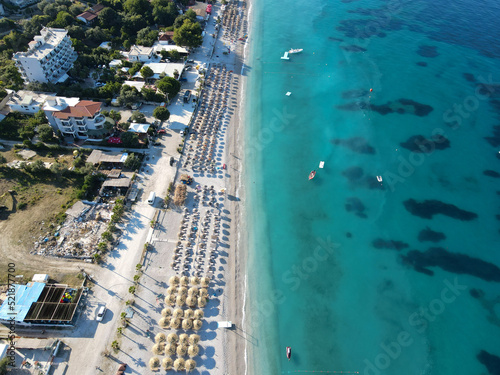 Drone photo of the summer beach resort with umbrellas at the Ionian Sea coast in Albania, Borsch