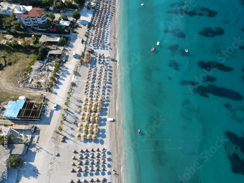 Drone photo of the summer beach resort with umbrellas at the Ionian Sea coast in Albania, Borsch © kriina2000