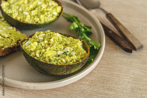 home cooked avocado and egg pate in shells and toast with it on a plate