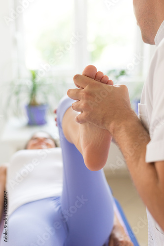 Wallpaper Mural Young woman exercising on physiotherapy with help of physiotherapist during rehabilitation Torontodigital.ca