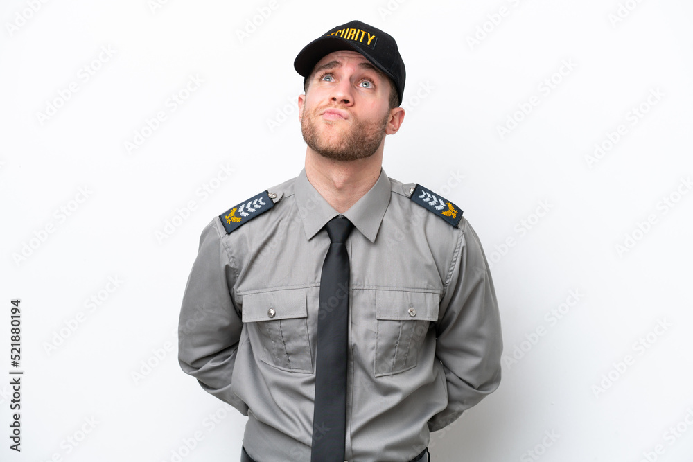 Young safeguard caucasian man isolated on white background and looking up Young safeguard caucasian man isolated on white background and looking up