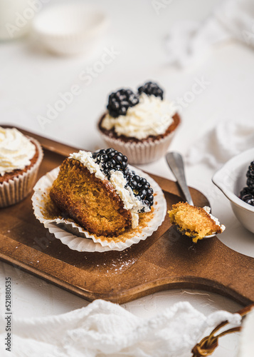 muffin cupcake paper mold carrot cake topped with whipped cream and berries blackberry