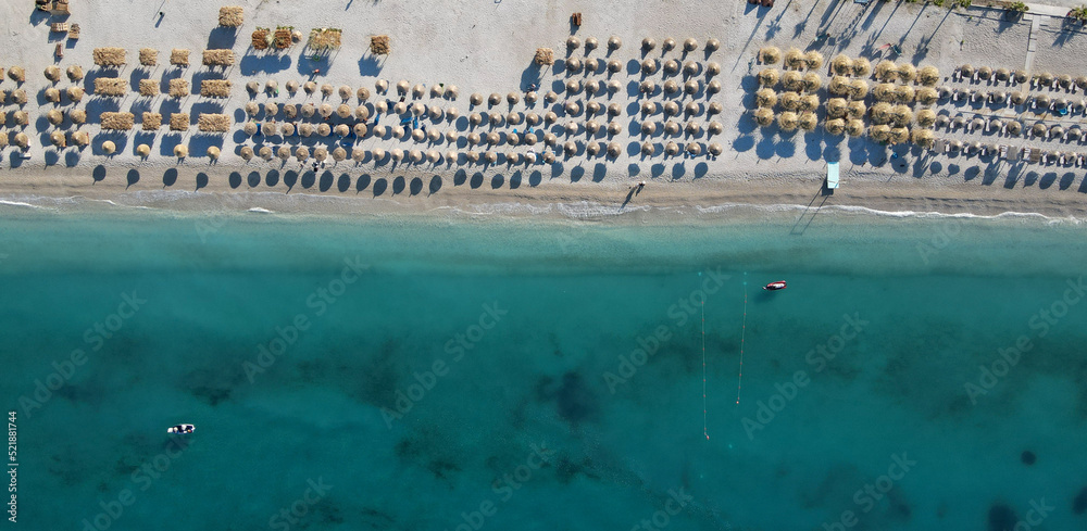 Drone photo of the summer beach resort with umbrellas at the Ionian Sea coast in Albania, Borsch