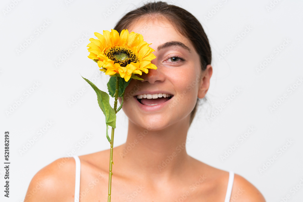 Young Pretty caucasian woman isolated on white background holding a sunflower while smiling. Close up portrait