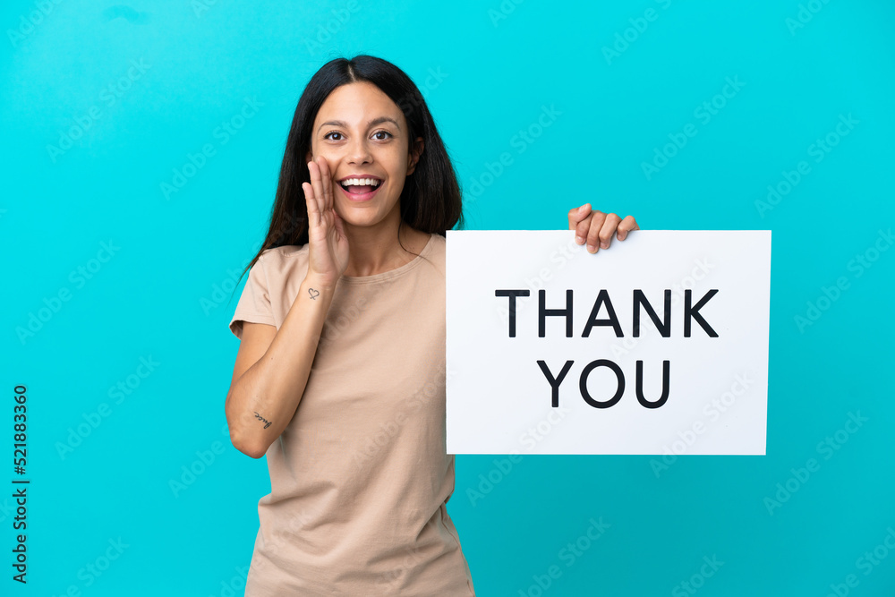 Young woman over isolated background holding a placard with text THANK YOU and shouting Young woman over isolated background holding a placard with text THANK YOU and shouting