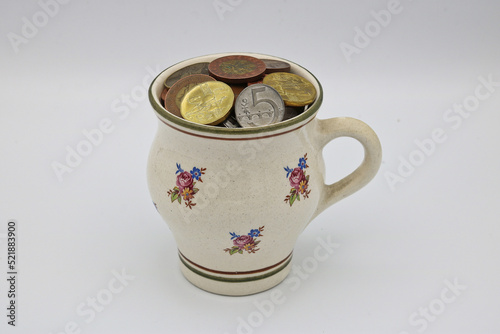 A mug full of saved coins photo