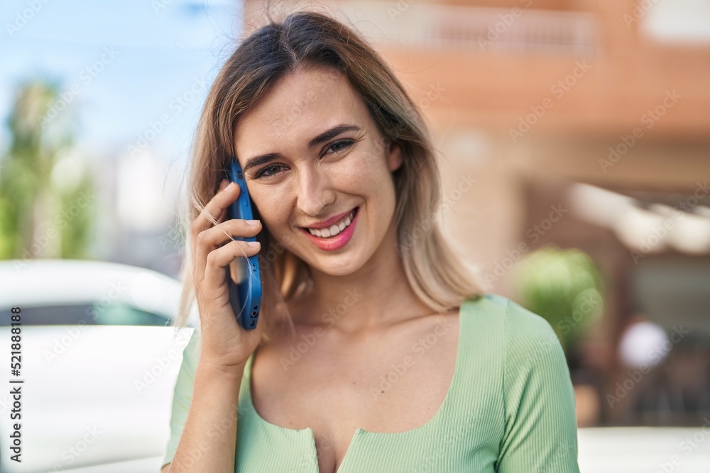 Young woman smiling confident talking on the smartphone at street Young woman smiling confident talking on the smartphone at street