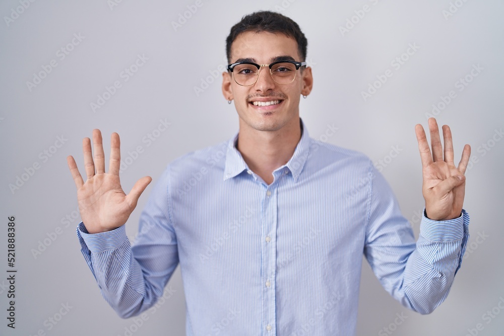 Handsome hispanic man wearing business clothes and glasses showing and pointing up with fingers number nine while smiling confident and happy. Handsome hispanic man wearing business clothes and glasses showing and pointing up with fingers number nine while smiling confident and happy.