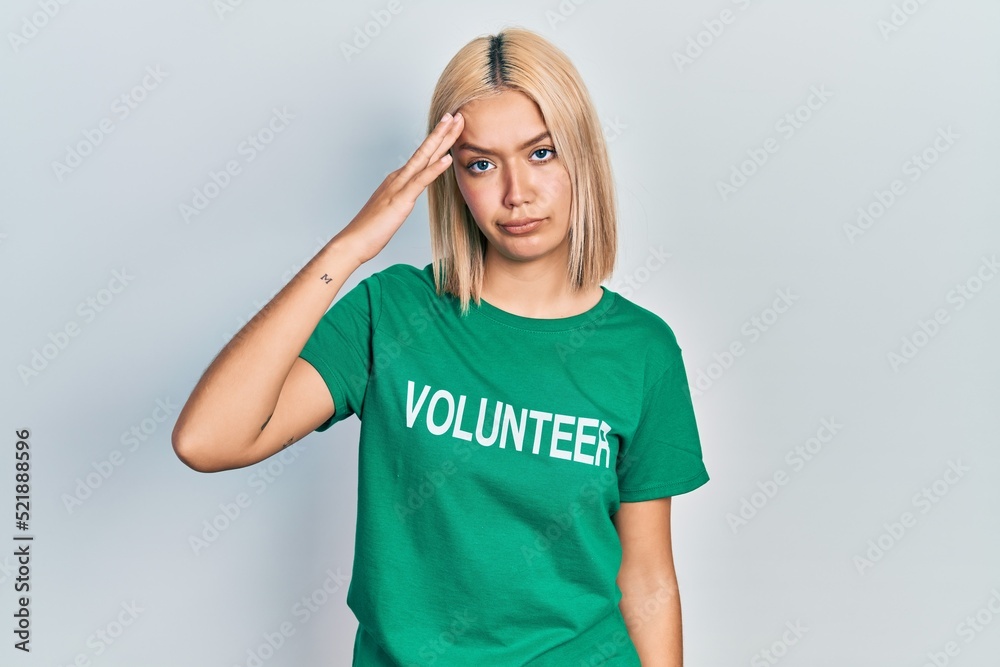 Beautiful blonde woman wearing volunteer t shirt worried and stressed about a problem with hand on forehead, nervous and anxious for crisis Beautiful blonde woman wearing volunteer t shirt worried and stressed about a problem with hand on forehead, nervous and anxious for crisis