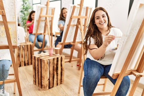 Group of women smiling happy drawing at art studio.