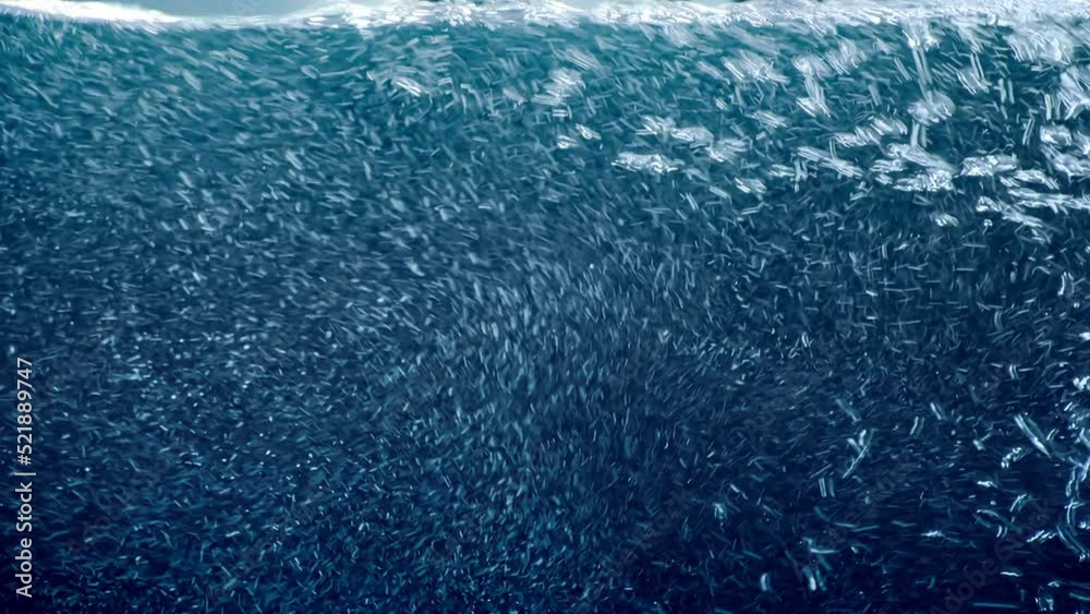 Water surface level rising full-screen against sun background. Carbonized bubbles moving up filling clear refreshing liquid. Concept shot for summer holidays copy text, renewable solar or hydro energy