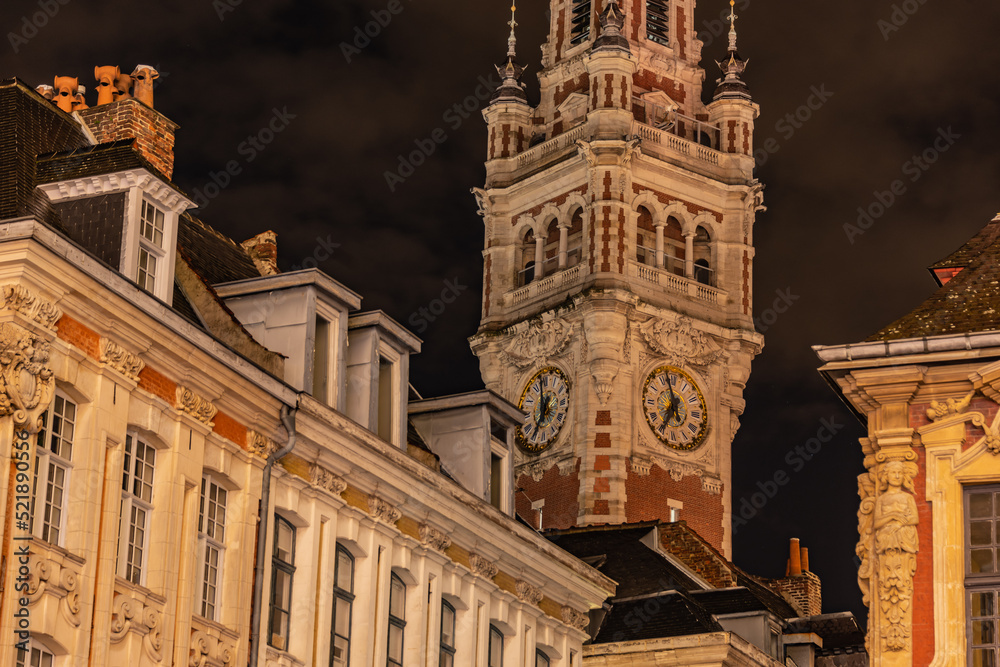 old style french town hall in european town at night with colors