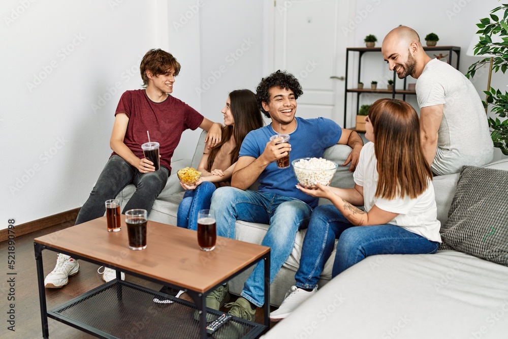 Group of young friends having party sitting on the sofa at home. Group of young friends having party sitting on the sofa at home.
