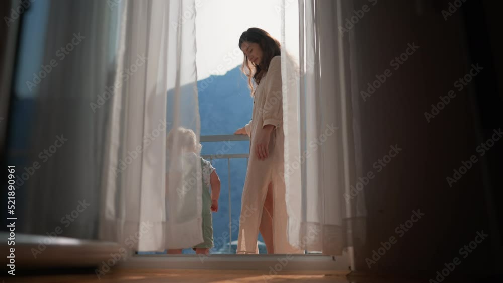 Baby toddler boy standing with tender mother on balcony at tropical beach resort. family love child and woman person in moring house, happy childhood lifestyle, vacation seaside background, relax view Baby toddler boy standing with tender mother on balcony at tropical beach resort. family love child and woman person in moring house, happy childhood lifestyle, vacation seaside background, relax view