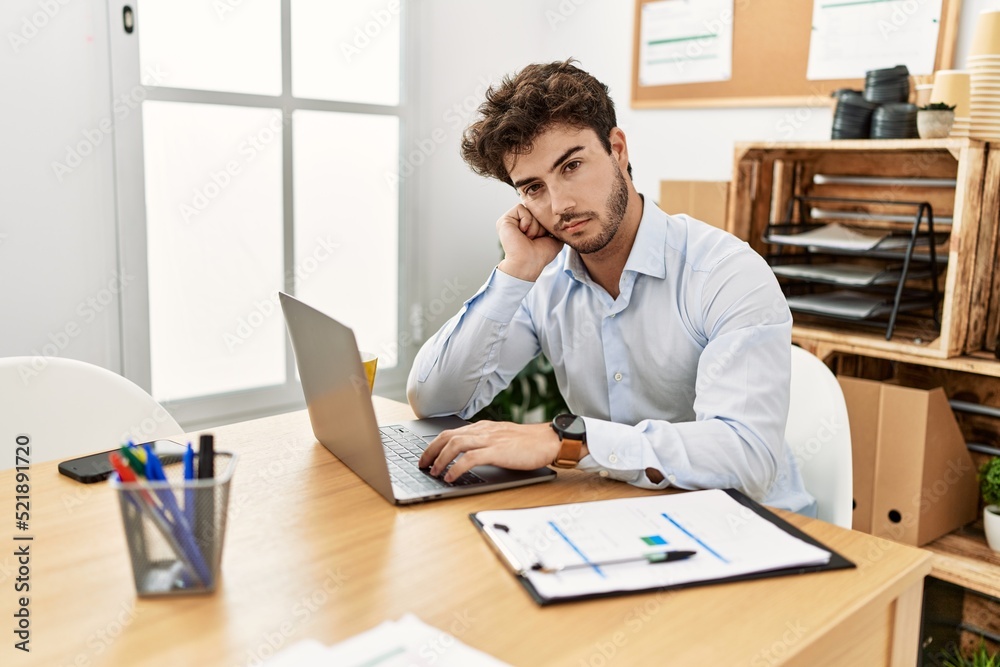 Young hispanic businessman relaxed working at the office. Young hispanic businessman relaxed working at the office.