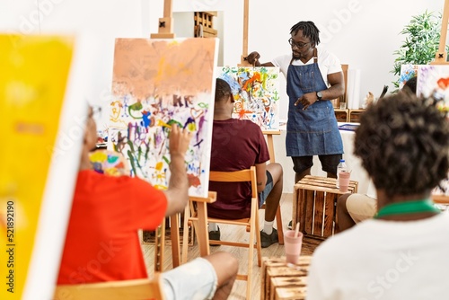 Group of young african american artist students drawing in paint class at art studio.