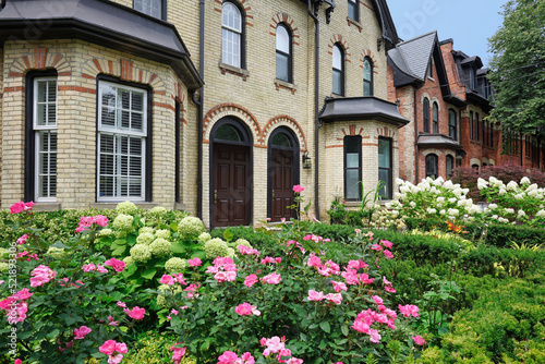 Well preserved Victorian row houses with beautiful flowers in front garden © Spiroview Inc.