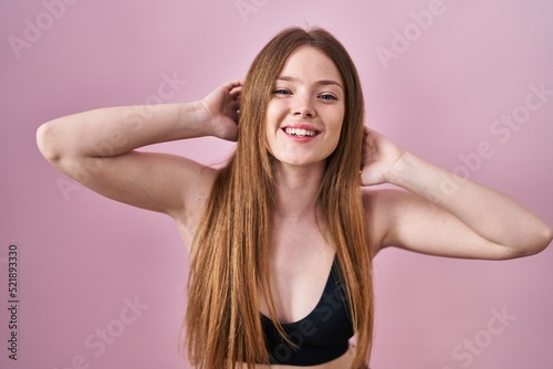 Young caucasian woman wearing lingerie over pink background smiling and laughing hard out loud because funny crazy joke.