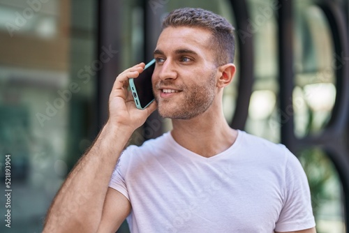 Young caucasian man smiling confident talking on the smartphone at street