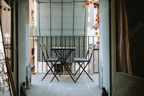 Canvas Print Empty cool and bohemian balcony with chairs and table.