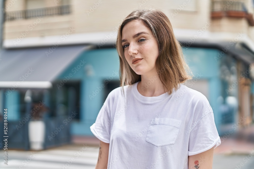 Young woman with relaxed expression standing at street Young woman with relaxed expression standing at street