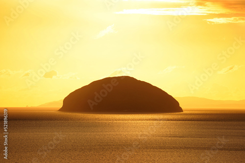 Fotobehang The rocky island of Ailsa Craig, seen here at sunset from Girvan, Scotland