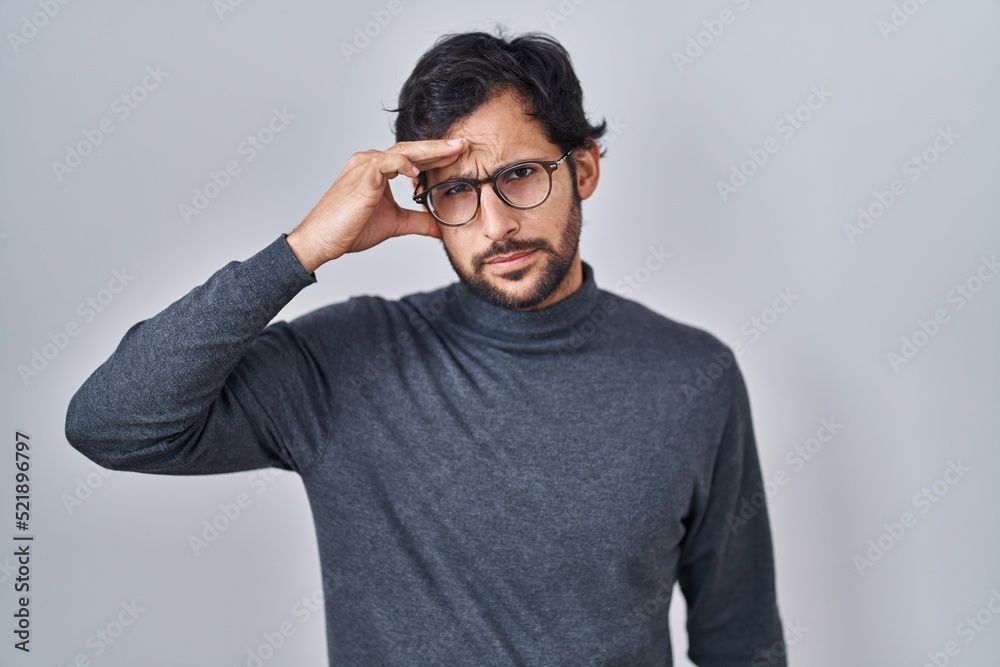 Handsome latin man standing over isolated background pointing unhappy to pimple on forehead, ugly infection of blackhead. acne and skin problem Handsome latin man standing over isolated background pointing unhappy to pimple on forehead, ugly infection of blackhead. acne and skin problem