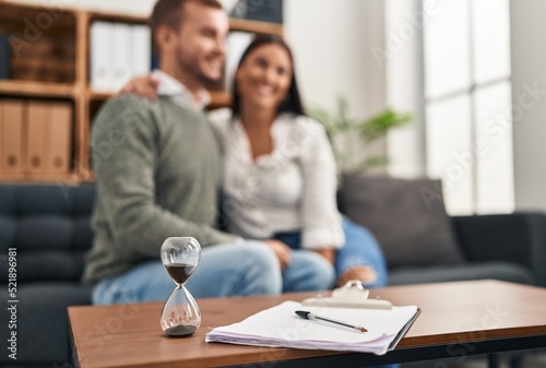 Man and woman hugging each other having couple therapy session at psychology clinic