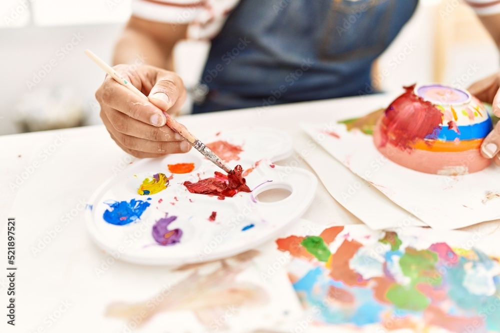 Artist man painting ceramic at art studio. Artist man painting ceramic at art studio.
