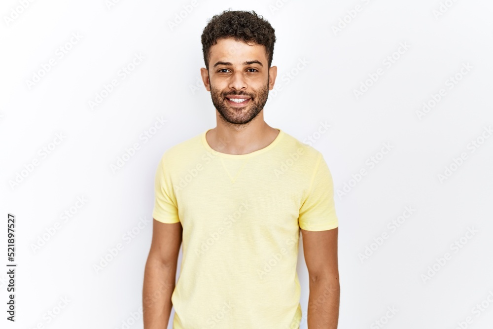 Arab young man standing over isolated background with a happy and cool smile on face. lucky person. Arab young man standing over isolated background with a happy and cool smile on face. lucky person.