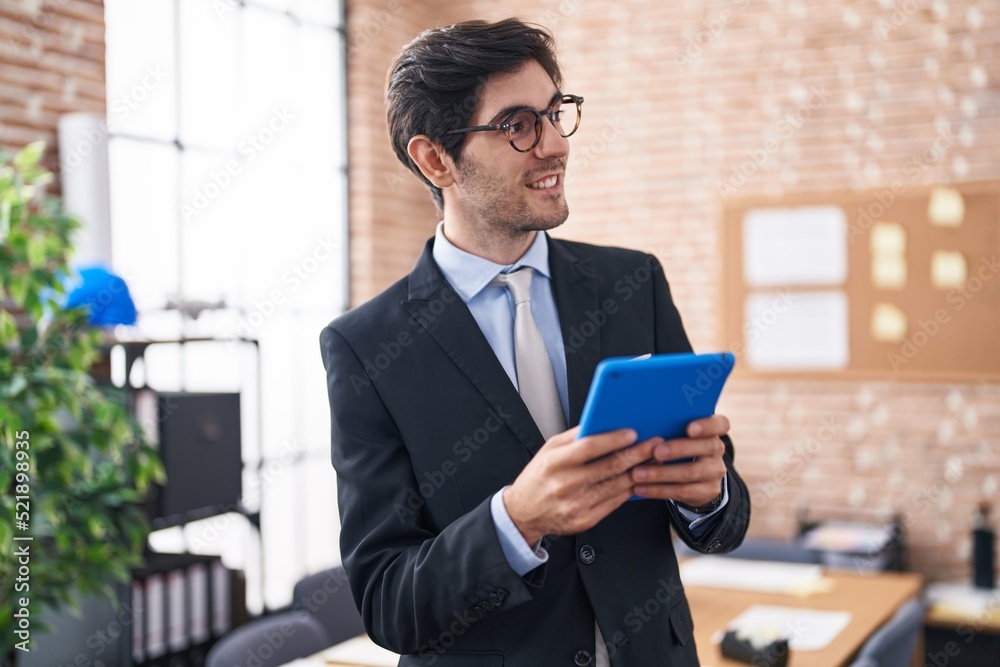 Young hispanic man business worker smiling confident using touchpad at office Young hispanic man business worker smiling confident using touchpad at office