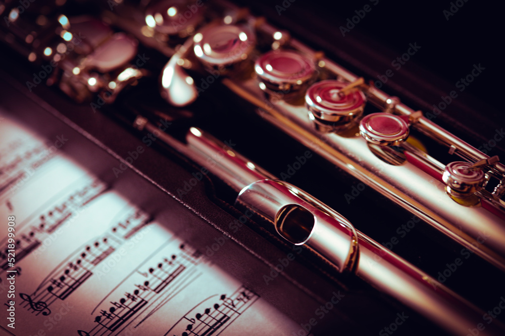 Close up of the flute musical instrument on the music sheet