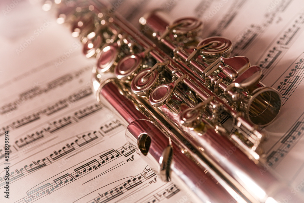 close up of the flute, musical instrument on the music sheet, artistic