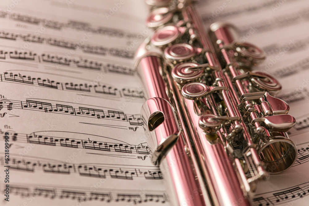 Flute on the music sheet close up artistic