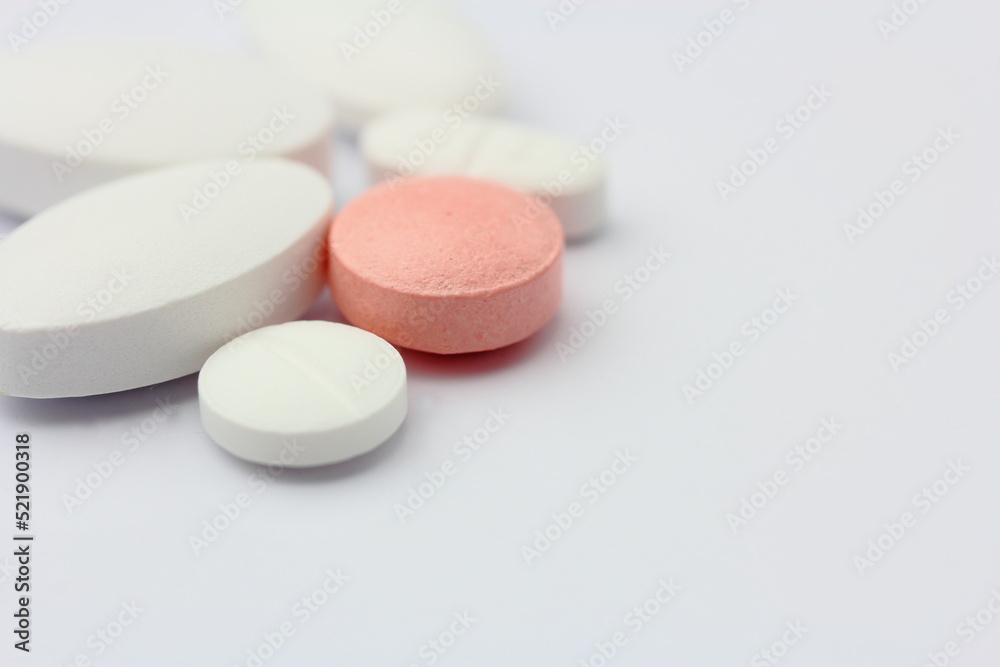 Various mixed medical tablets on white sterile table Various mixed medical tablets on white sterile table