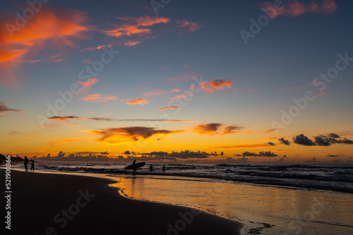 Heading Out with Surfboard in Morning Twilight