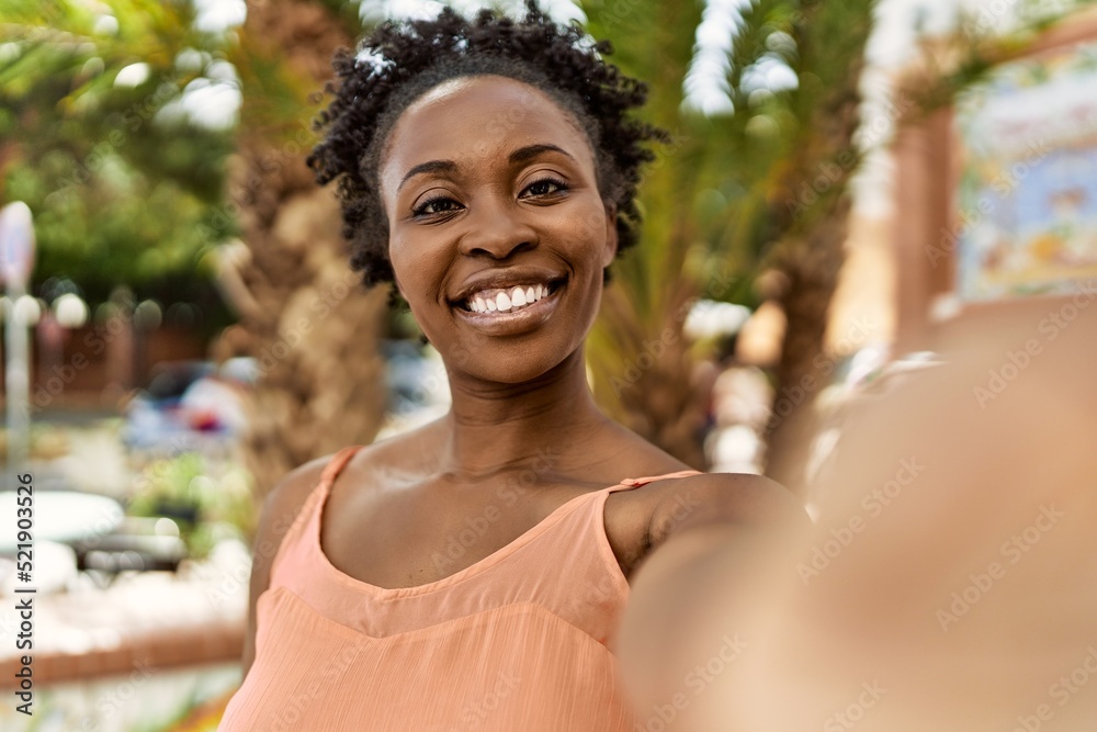 Young african american woman smiling happy on a summer day taking a selfie picture Young african american woman smiling happy on a summer day taking a selfie picture