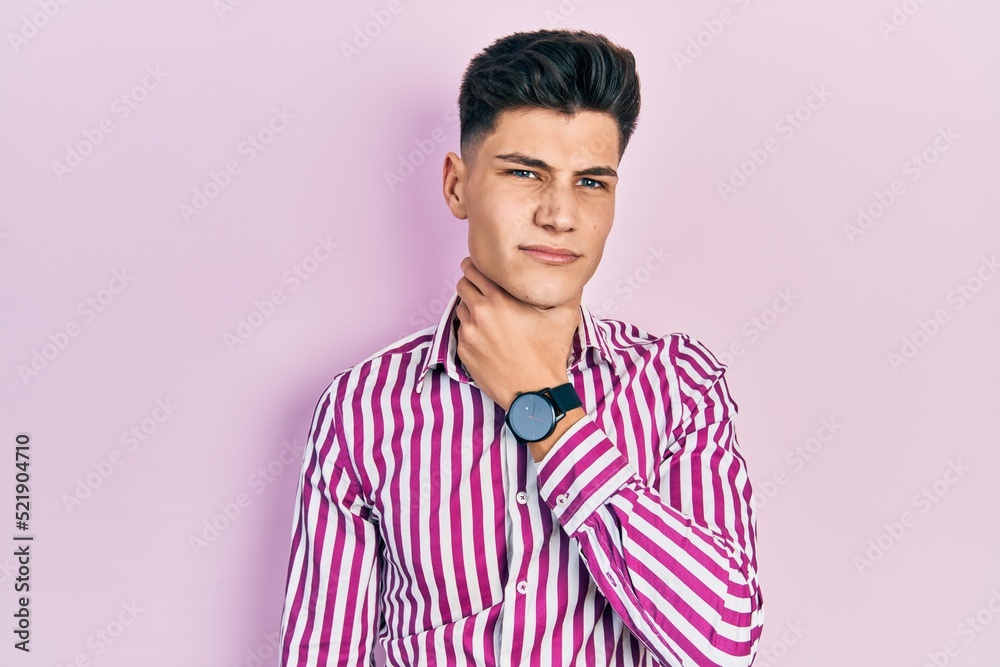 Young hispanic man wearing casual clothes touching painful neck, sore throat for flu, clod and infection Young hispanic man wearing casual clothes touching painful neck, sore throat for flu, clod and infection