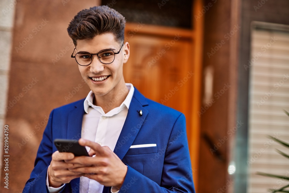 Young man using smartphone wearing suit and glasses at street Young man using smartphone wearing suit and glasses at street