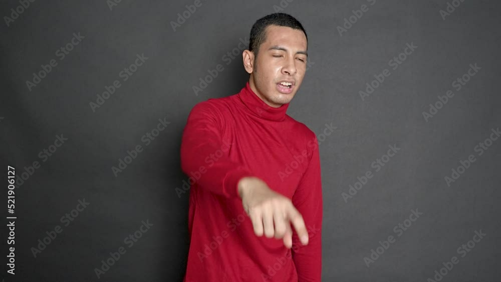 A young man lashing out by throwing his index finger to the front A young man lashing out by throwing his index finger to the front
