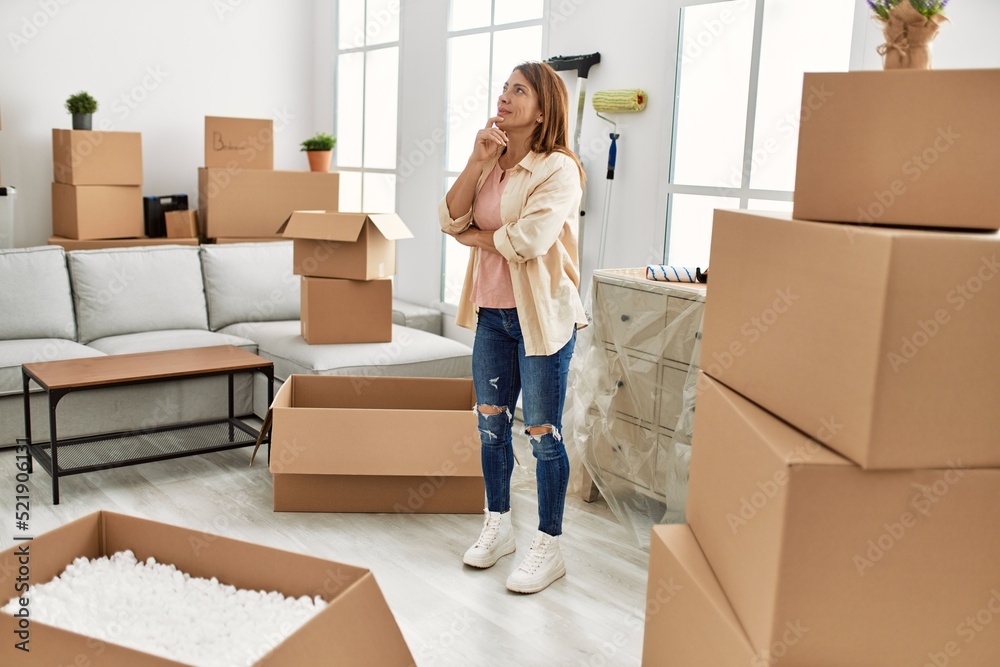 Middle age caucasian woman with relaxed expression standing at new home. Middle age caucasian woman with relaxed expression standing at new home.